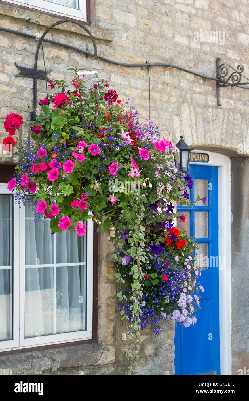 Hanging baskets outside a cottage in Stow on the Wold, Cotswolds Stock