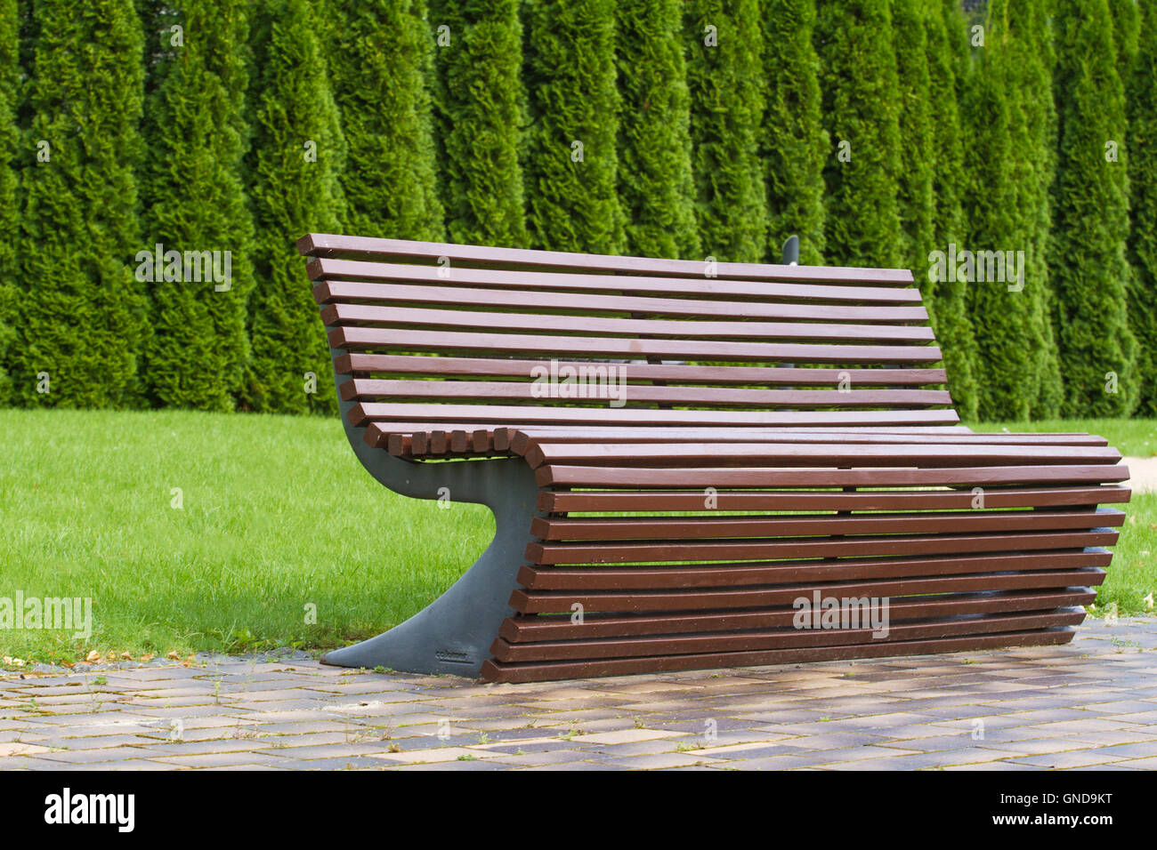 Stylish Curve Shaped Brown Wooden Bench Outdoor Furniture In The - Stock Photo Stylish Curve Shaped Brown Wooden Bench Outdoor Furniture Inthe Park As Background Image stylish curve shaped brown wooden bench outdoor furniture in the - stock photo stylish curve shaped brown wooden bench outdoor furniture inthe park as background image