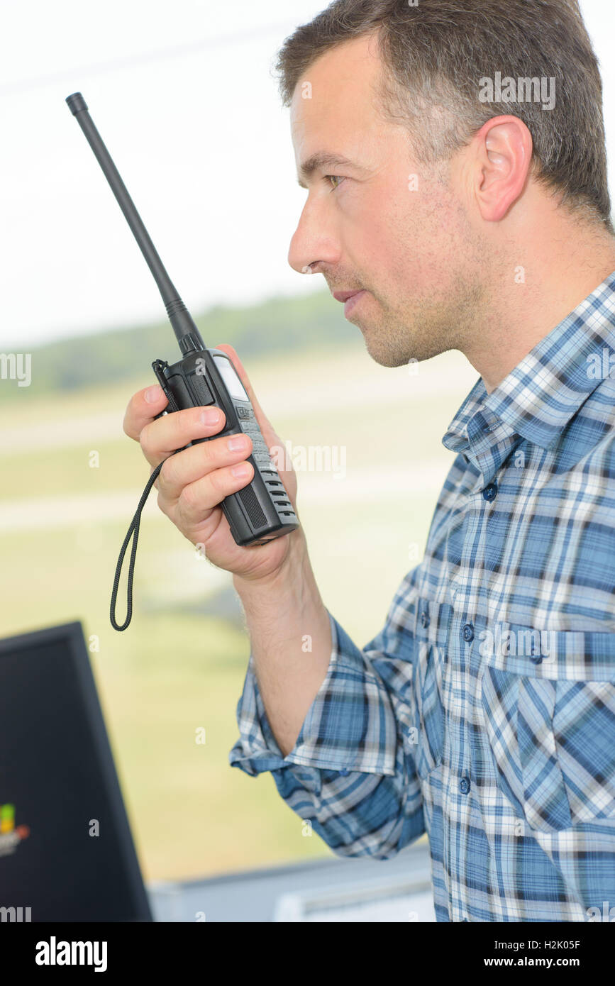 Man talking into walkie talkie Stock Photo, Royalty Free Image