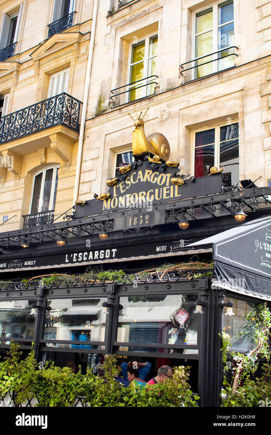 People have lunch at one of the traditional French bistro in Paris