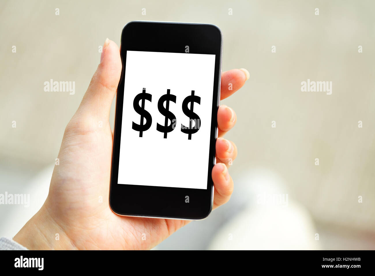 Human Hand Holding Mobile Phone With Dollar Sign On Screen Stock Photo