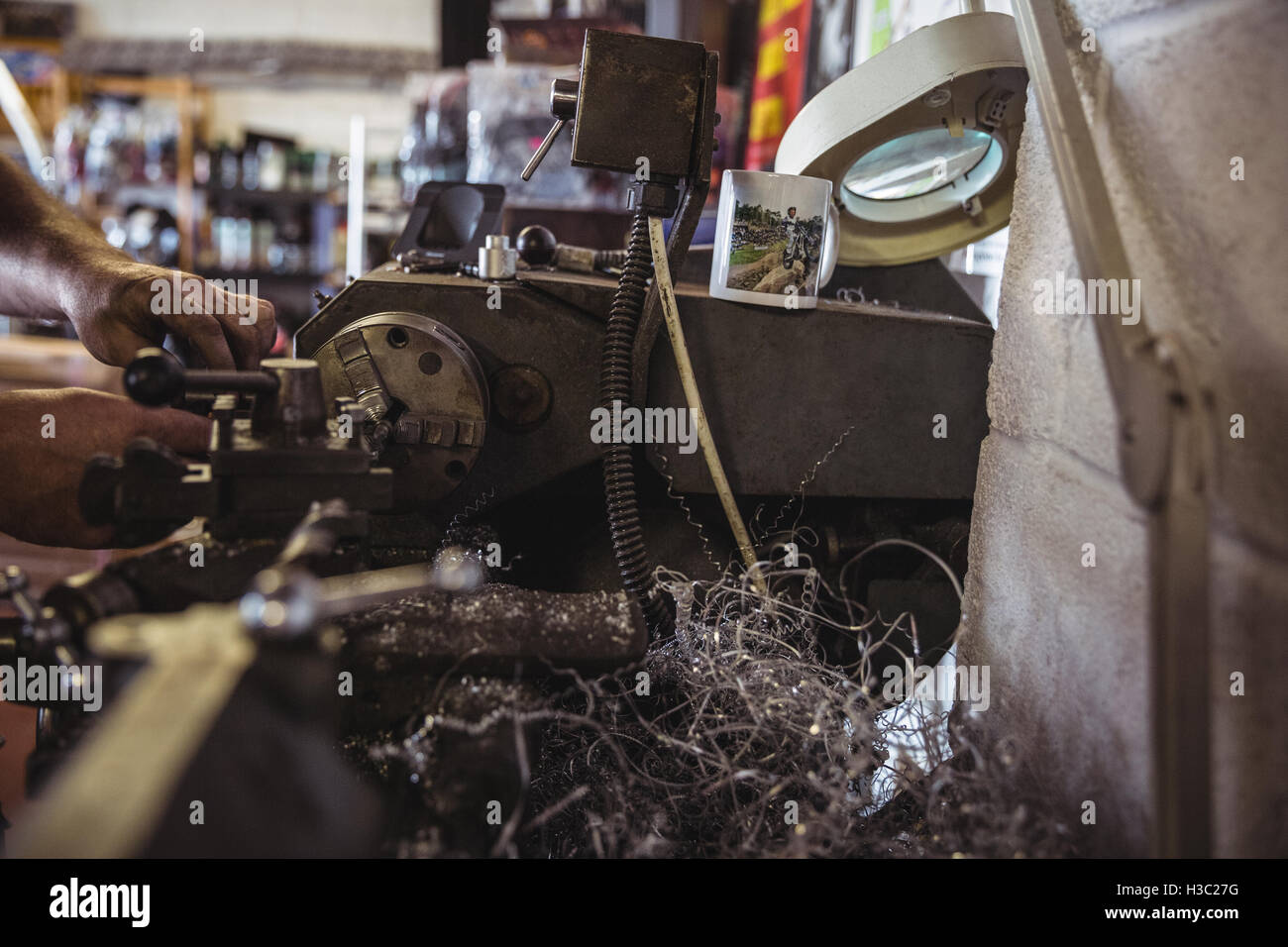 Mechanic working on a lathe machine Stock Photo, Royalty Free Image