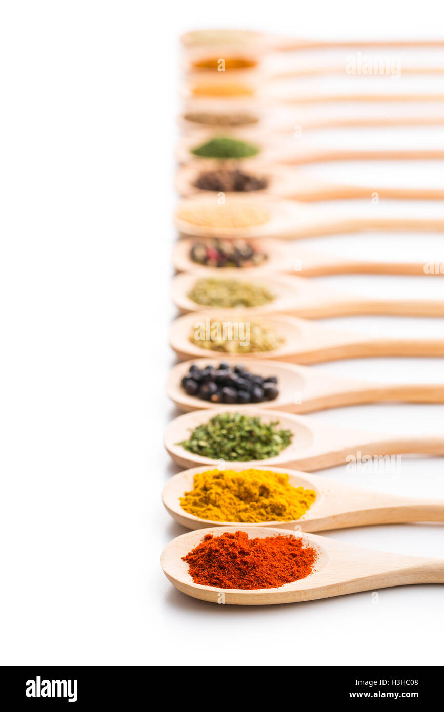 Various Spices In Wooden Spoons Isolated On White Background Stock