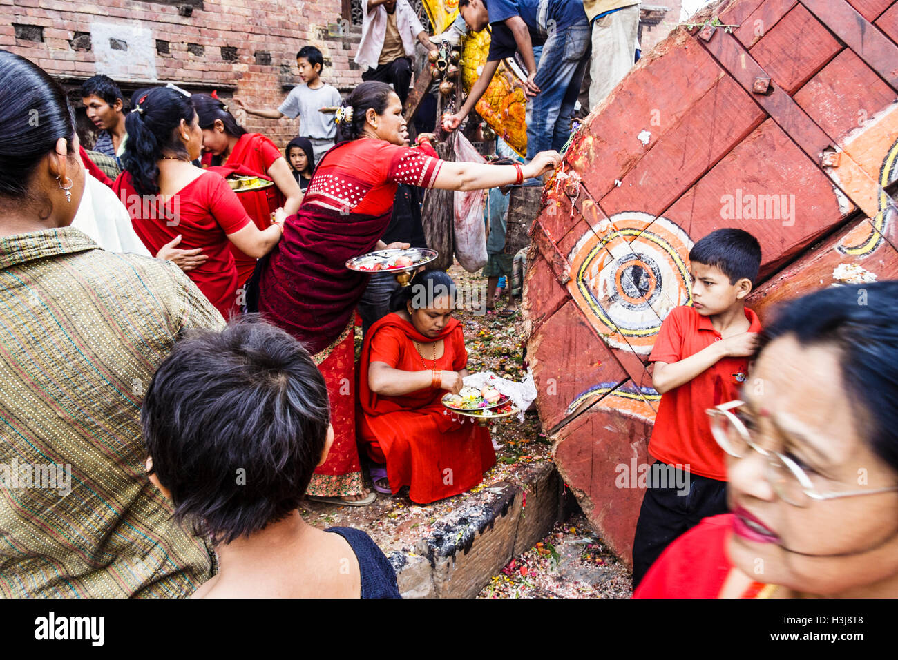 Newari Women Dressed In Red Offering Puja To The Bisket Jatra Chariot