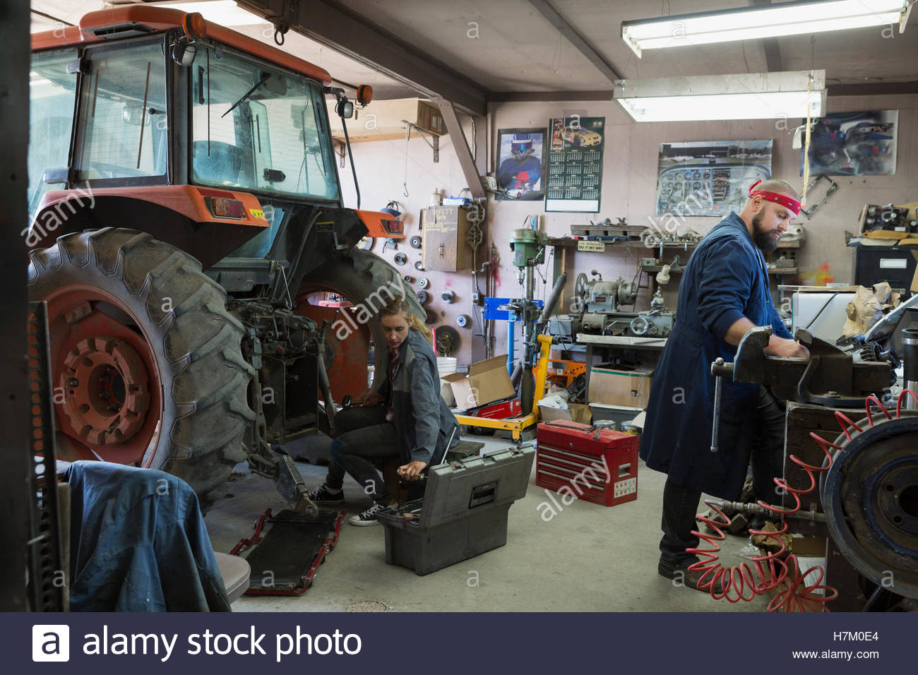 Mechanics working on tractor in Stock Photo, Royalty Free