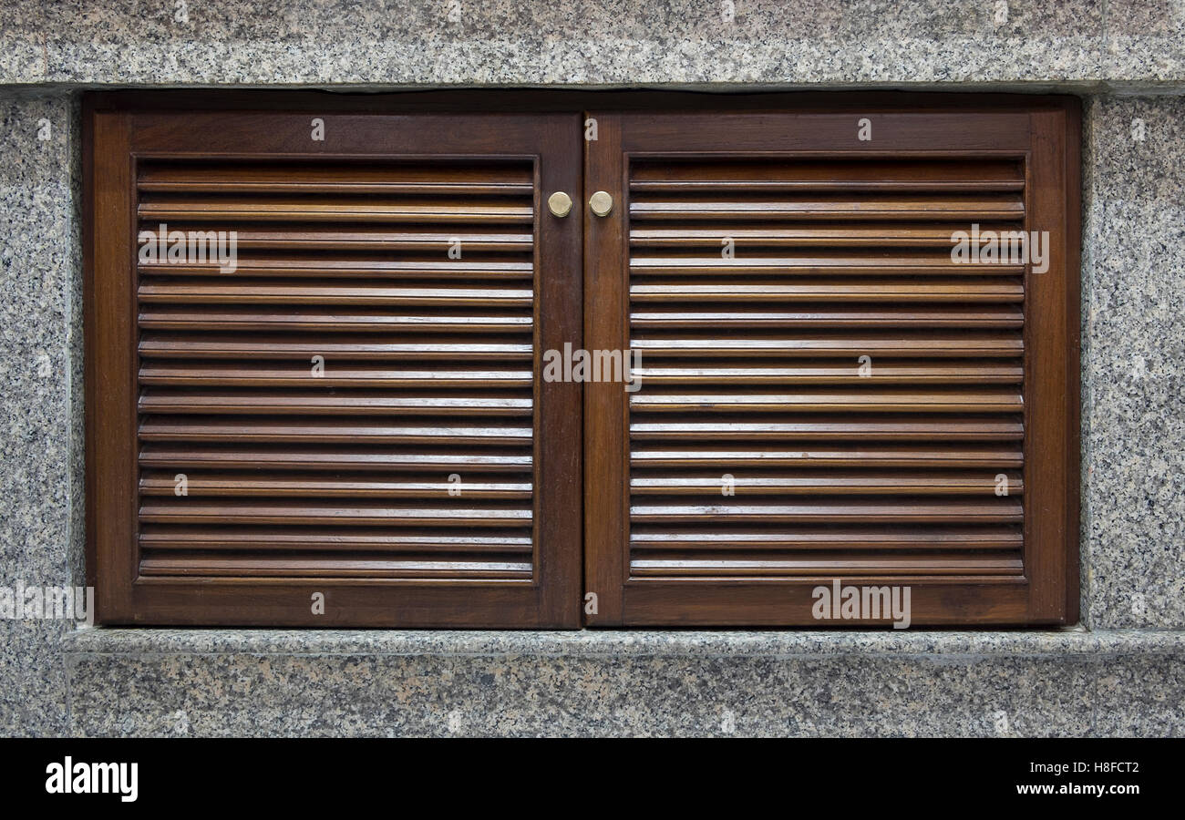 Dark wooden door and window shutter with louvers and granite for ... Dark wooden door and window shutter with louvers and granite for ...