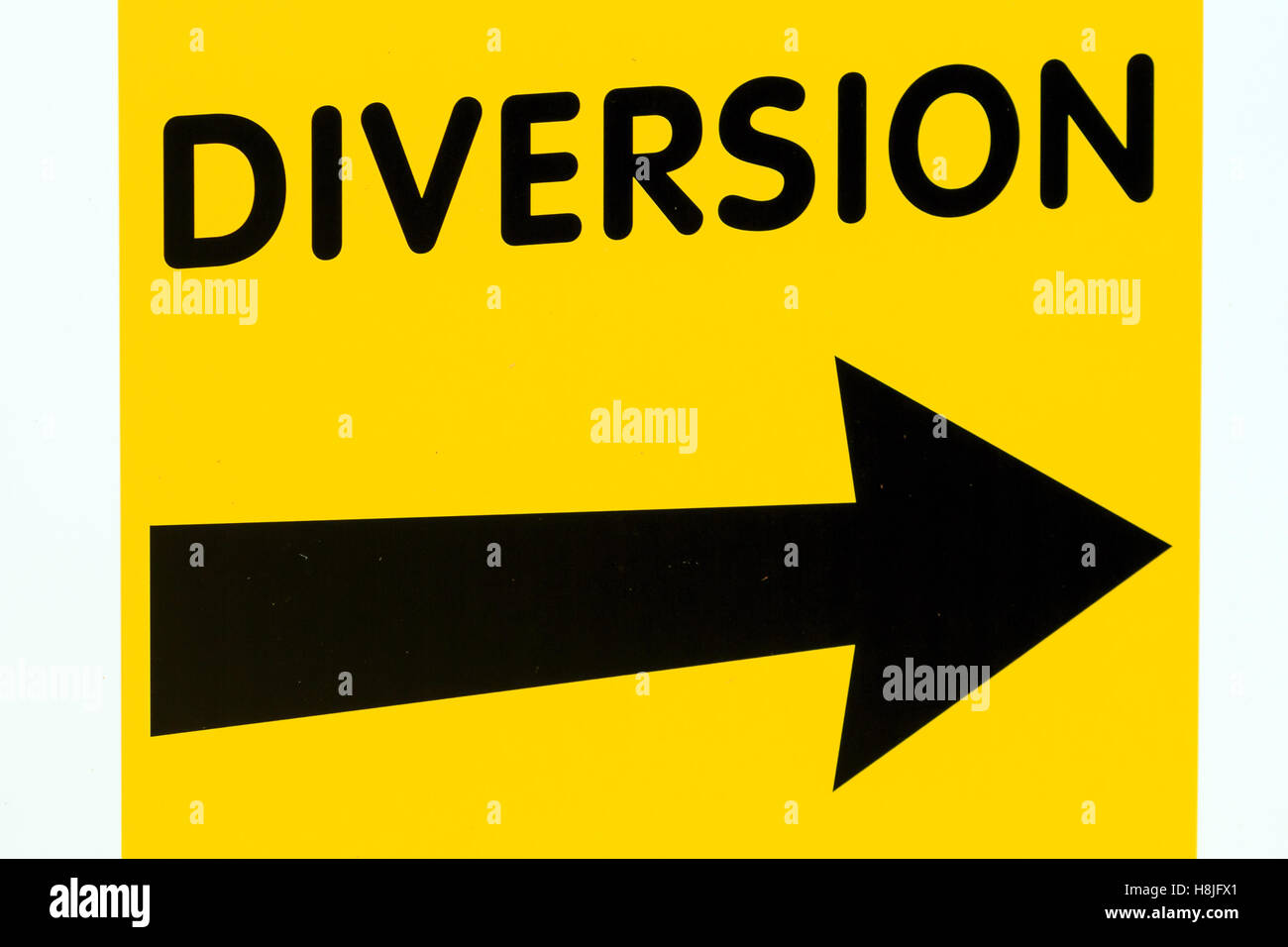 Yellow diversion sign board with black Right pointing arrow Stock Photo