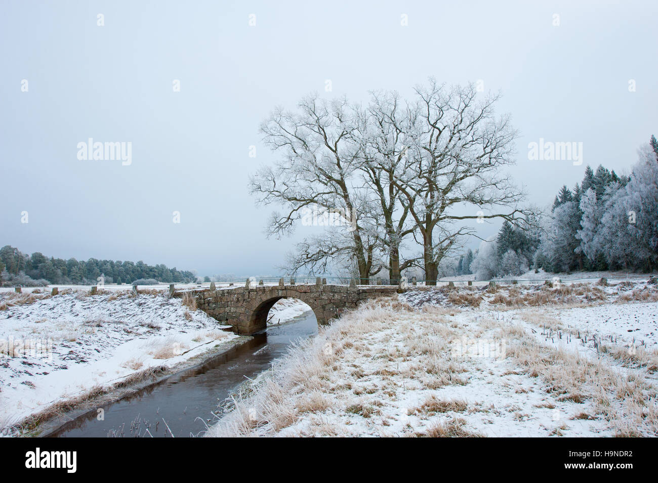 A Beautiful Old Stone Bridge In A Frosty Landscape Stock Photo Alamy