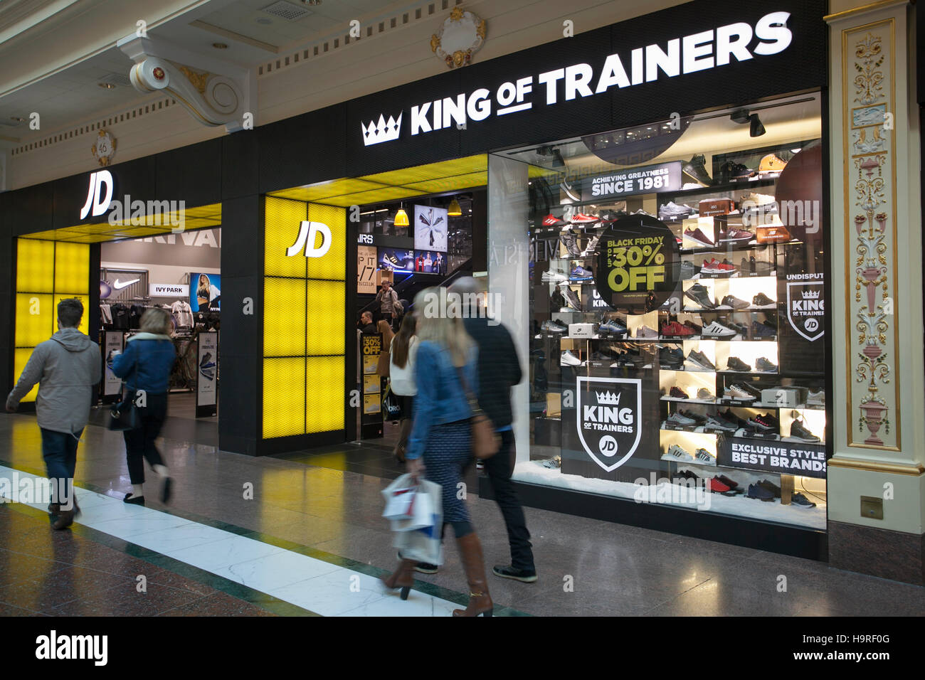 People passing JD King of Trainers at INTU Trafford Centre Stock Photo