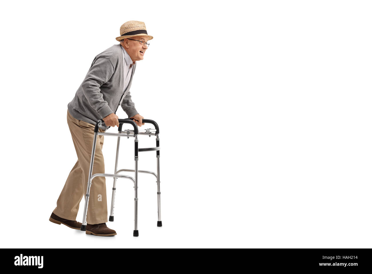 Full length profile shot of a senior walking with a walker isolated