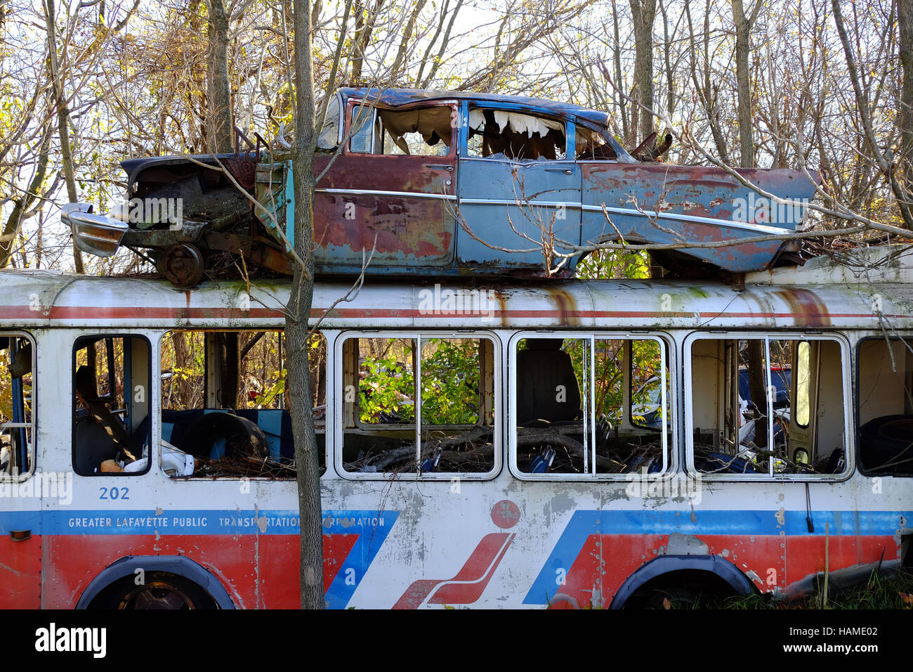 An old city bus is abandoned in a junkyard in Frankfort, Indiana with