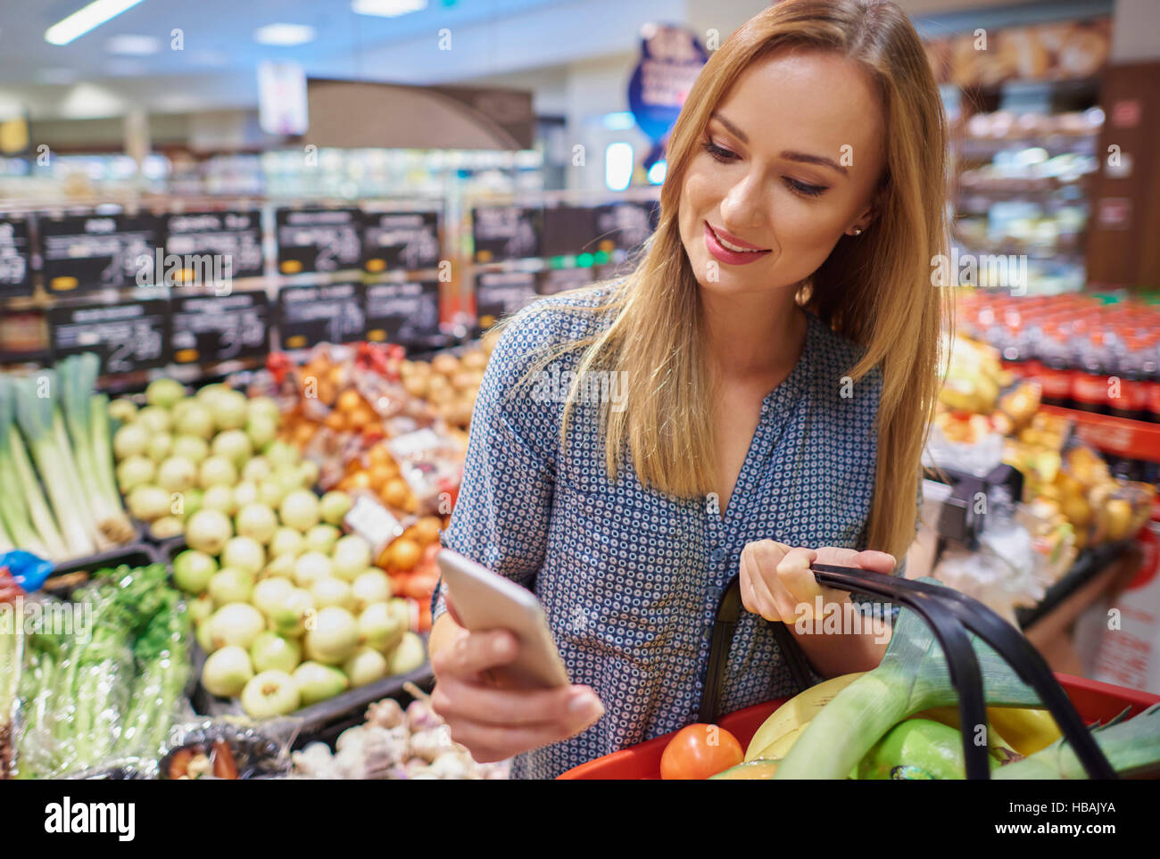 Woman Using Cellphone In Grocery Store Stock Photo Alamy