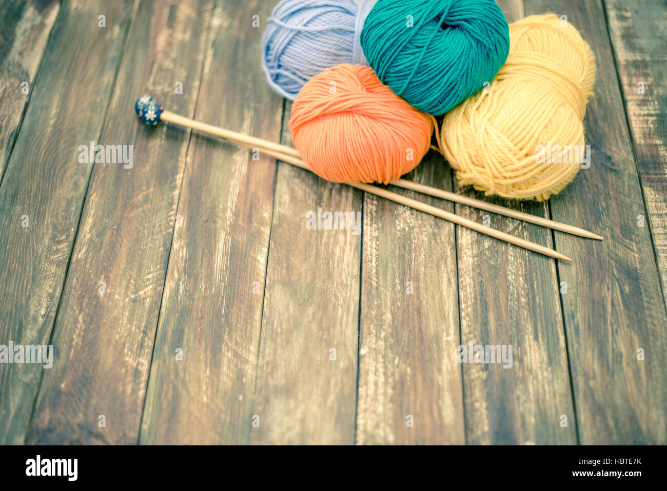 Yarn With Knitting Needles On Wooden Background Stock Photo