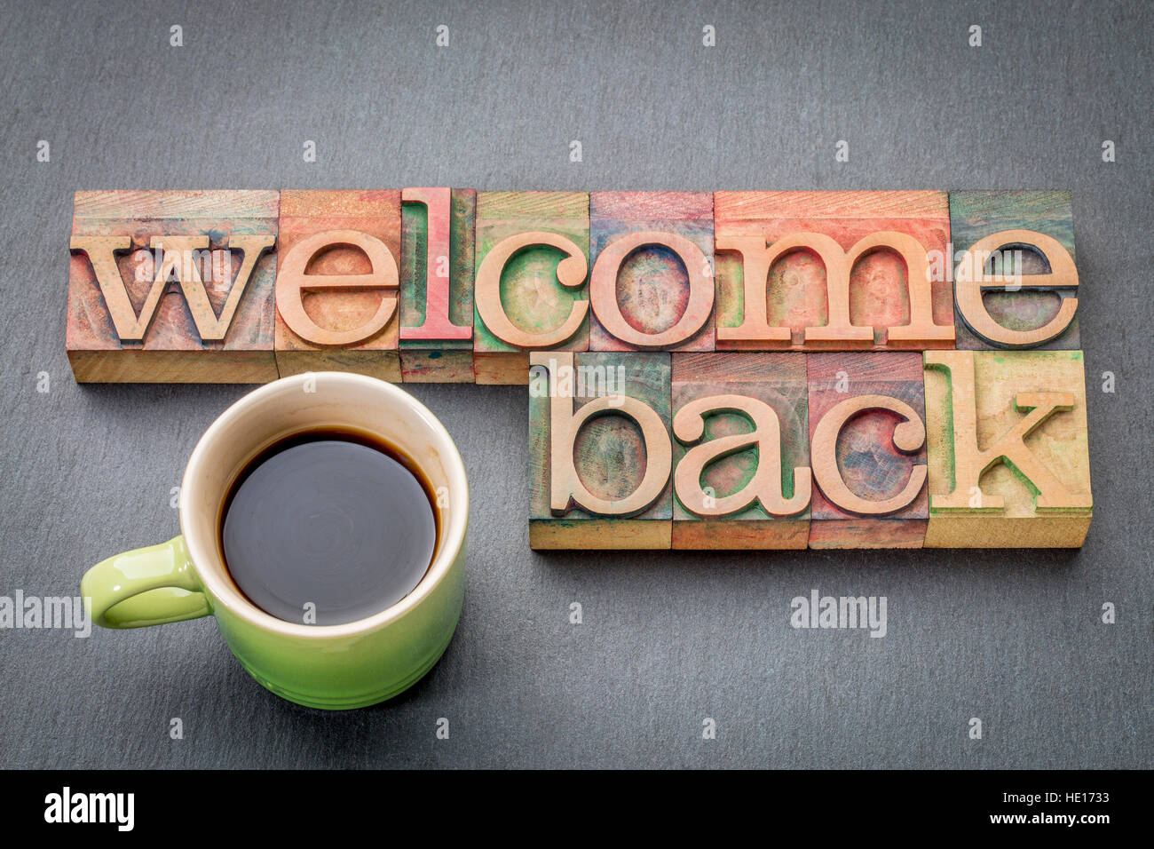 welcome-back-sign-text-in-letterpress-wood-type-with-a-cup-of-coffee-HE1733.jpg