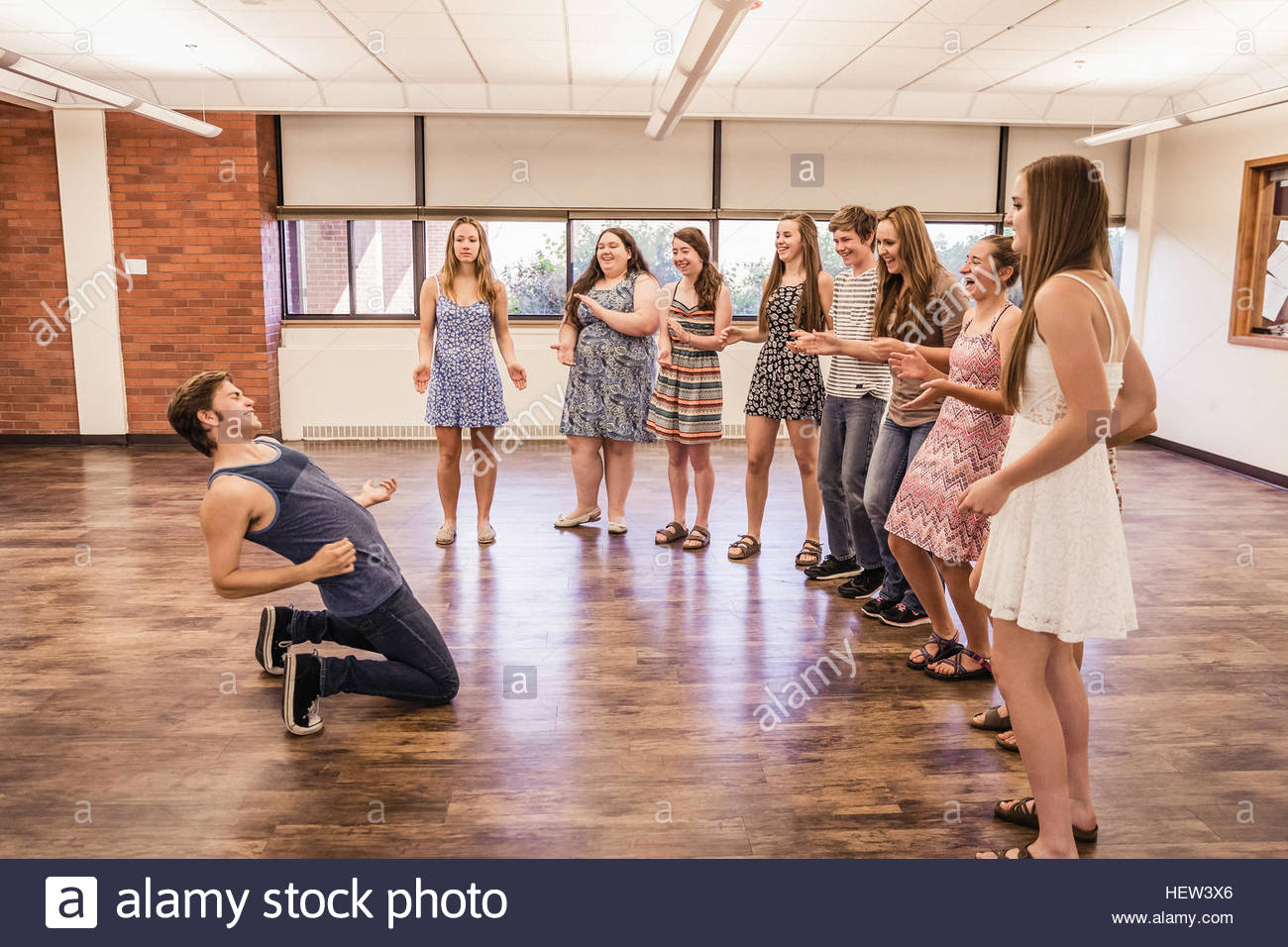 Class of teenagers applauding teenage boy dancing in high school Class of teenagers applauding teenage boy dancing in high school