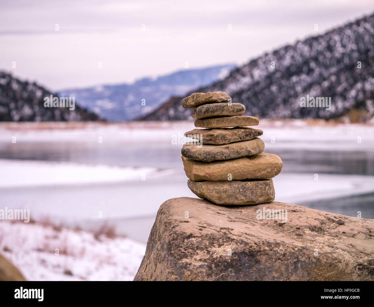 Rock Cairn With Frozen Lake In Background Stock Photo 129902875