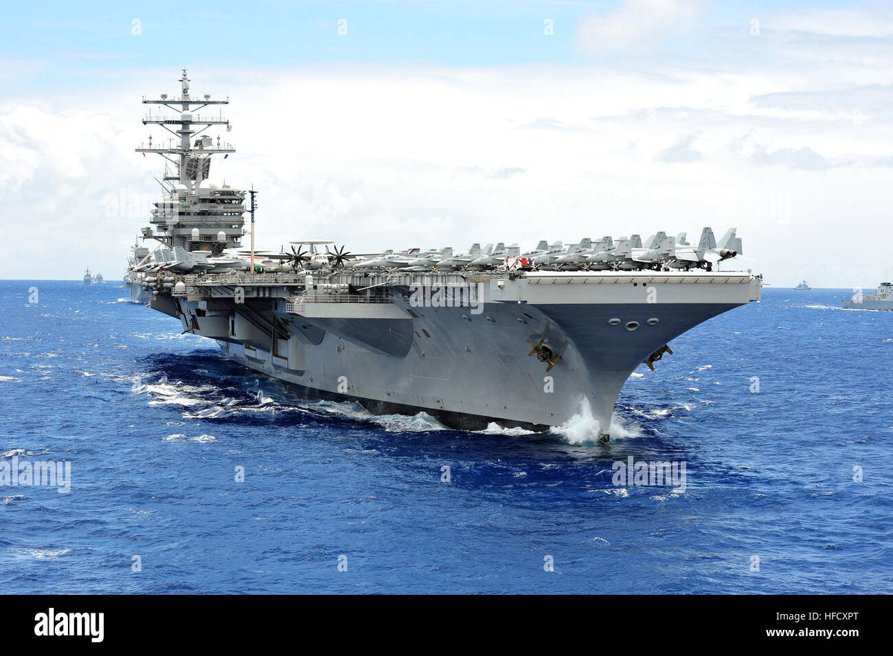 The aircraft carrier USS Ronald Reagan (CVN 76) leads a close Stock
