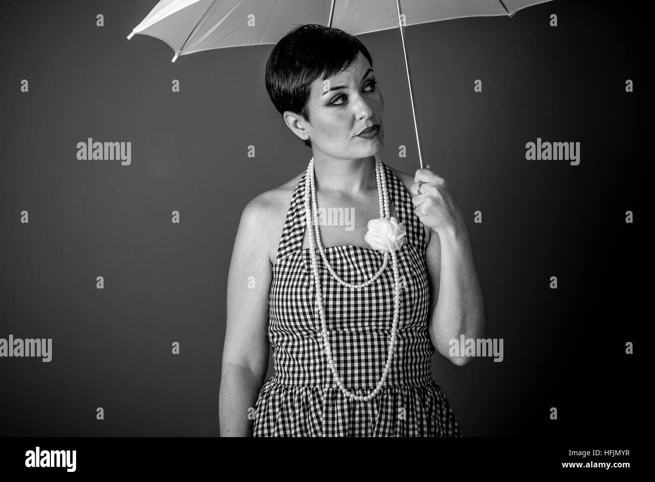 Girl Vintage 50s Dress With White Umbrella Over Blue Background Girl Vintage 50s Dress With White Umbrella Over Blue Background