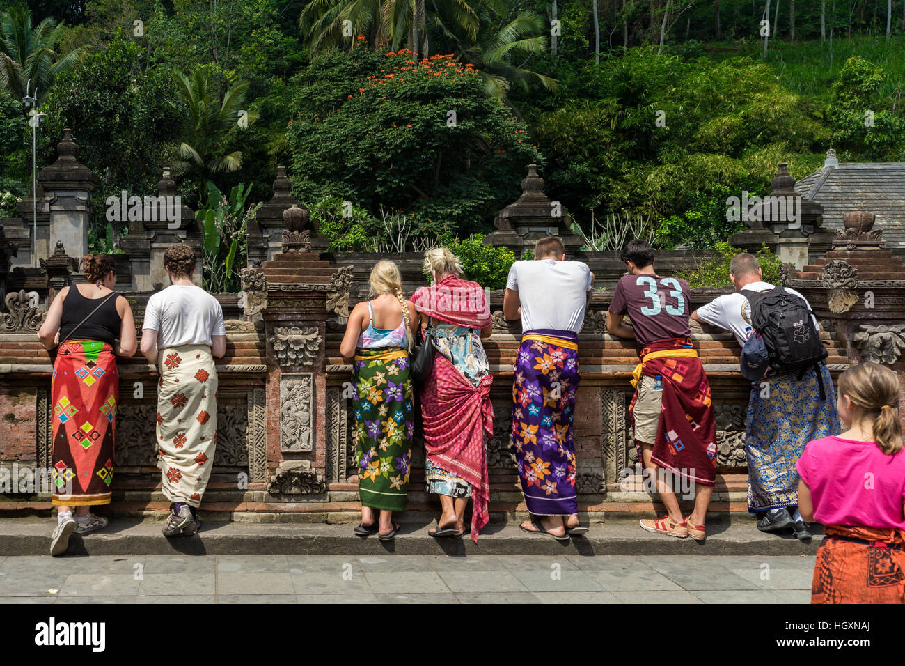 Tourists wearing traditional Balinese sarong at Tirta Empul temple