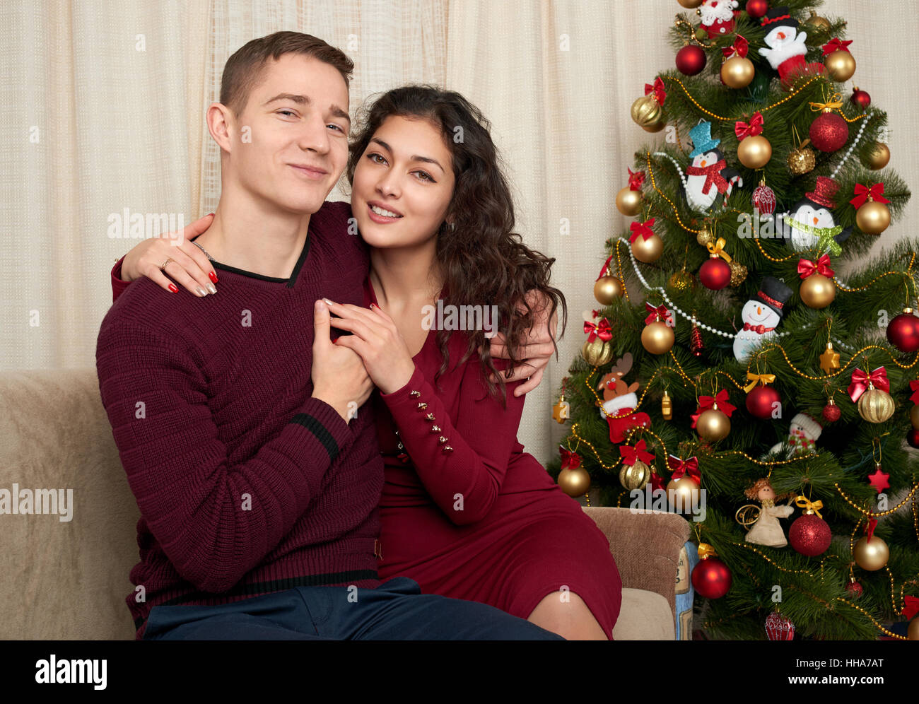 Happy couple in christmas decoration at home. New year eve, decorated Stock Photo, Royalty Free
