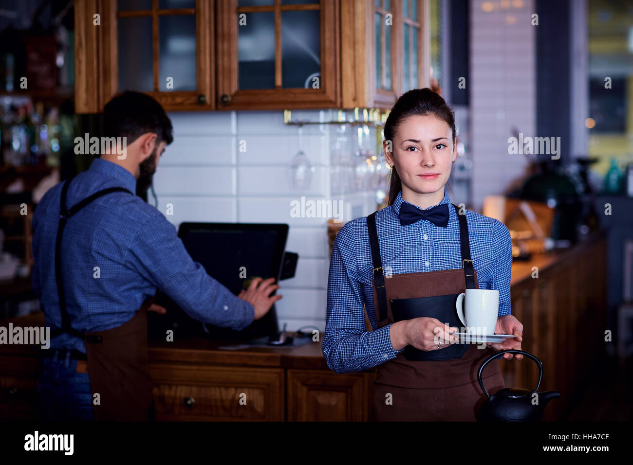 Waitress, a waiter working at cafe bar restaurant Stock Photo, Royalty