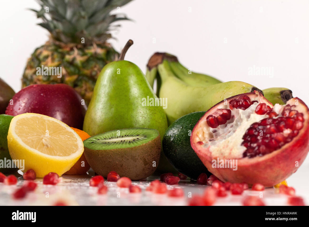 close-up of different tropical fruits. halved kiwi, lemon and