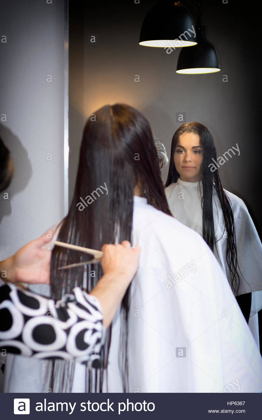 Hairdresser stylist styling long hair salon mirror Stock Photo, Royalty Free Image 134129247