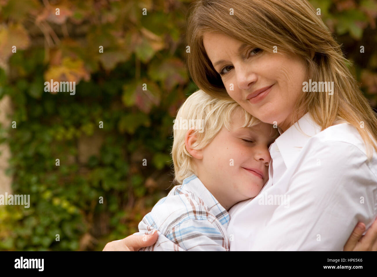 Happy Mother Hugging Her Son Outside Stock Photo Alamy