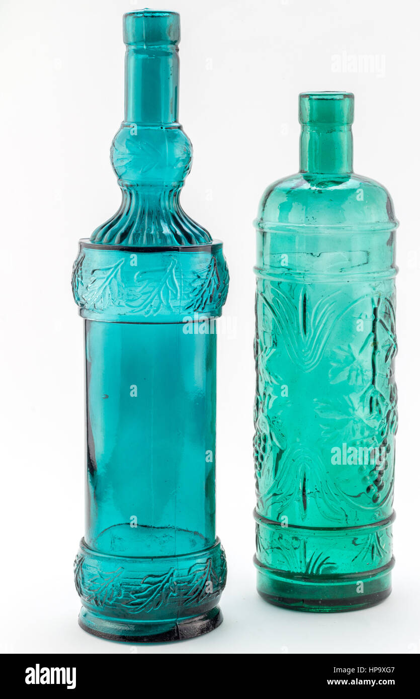 Two green / blue glass bottles blown from recycled glass in Spain Stock