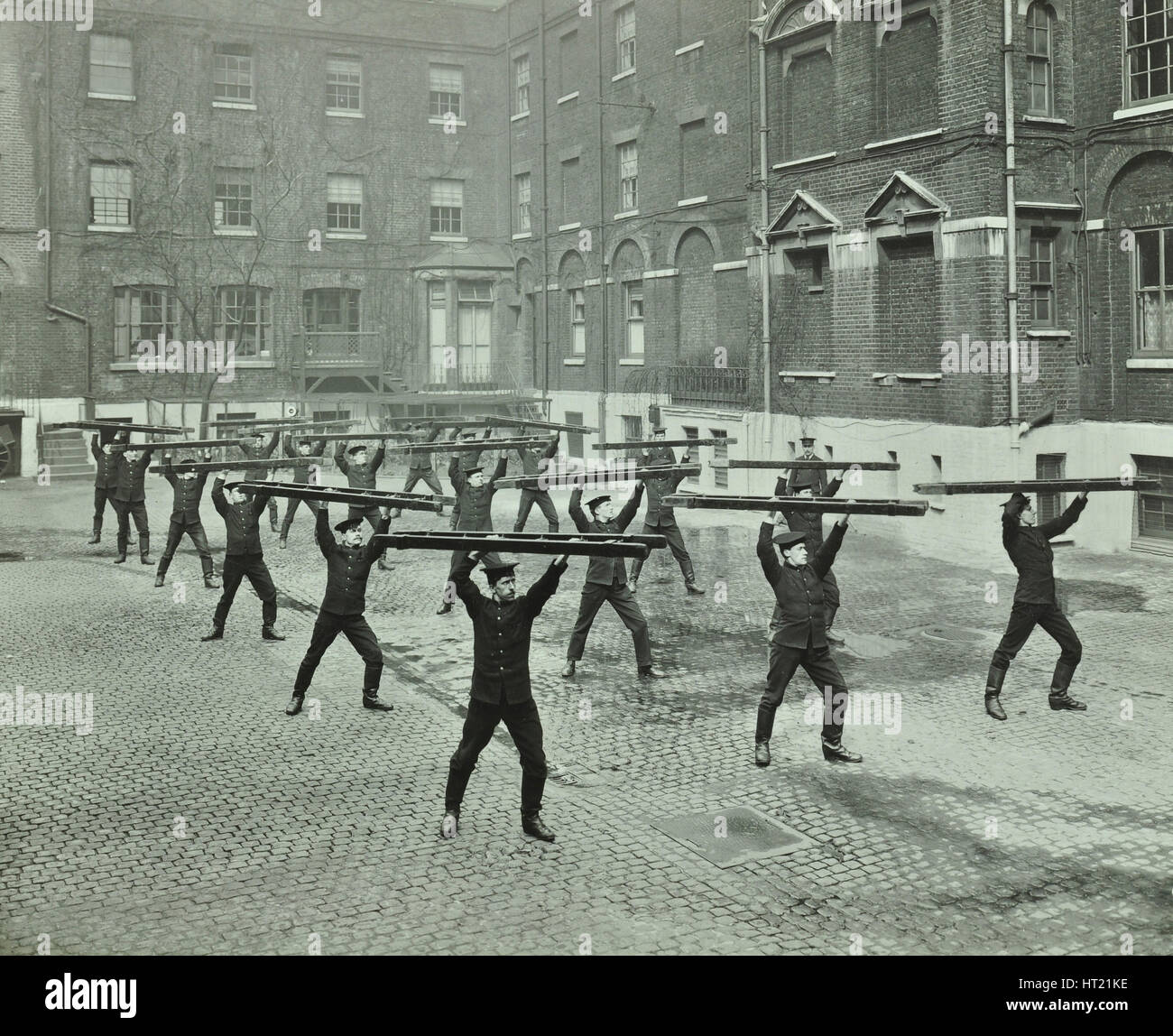Firemen carrying out scaling ladder drill, London Fire Brigade Stock