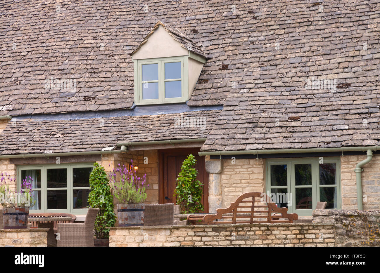 English Stone Cottage english stone cottage with lavender in barrels, garden bench English Stone Cottage english stone cottage with lavender in barrels, garden bench