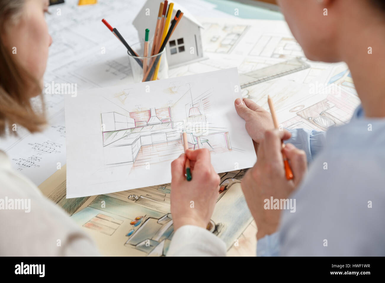 interior designers working on color hand drawings of a kitchen interior at work place photo of young designers work concept - How Interior Designers Work interior designers working on color hand drawings of a kitchen interior at work place photo of young designers work concept - How Interior Designers Work