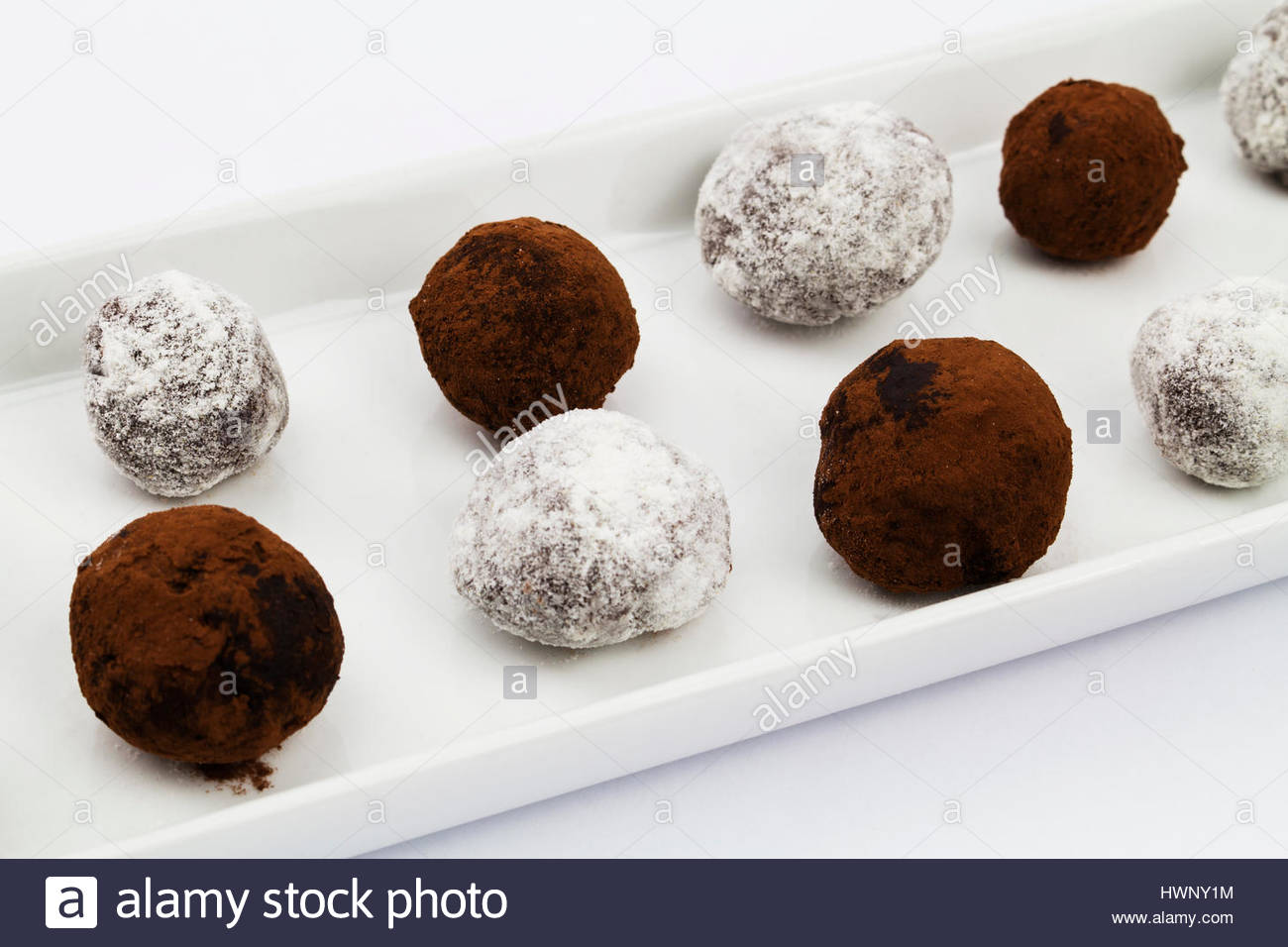A plate of cocoa dusted and sugar dusted truffle chocolates Stock Photo