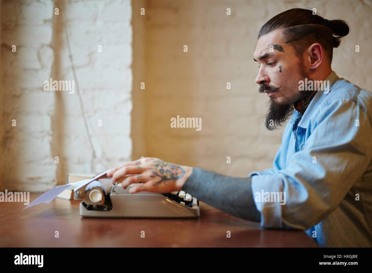 side view portrait of stylish creative man with tattoos and beard side view portrait of stylish creative man with tattoos and beard