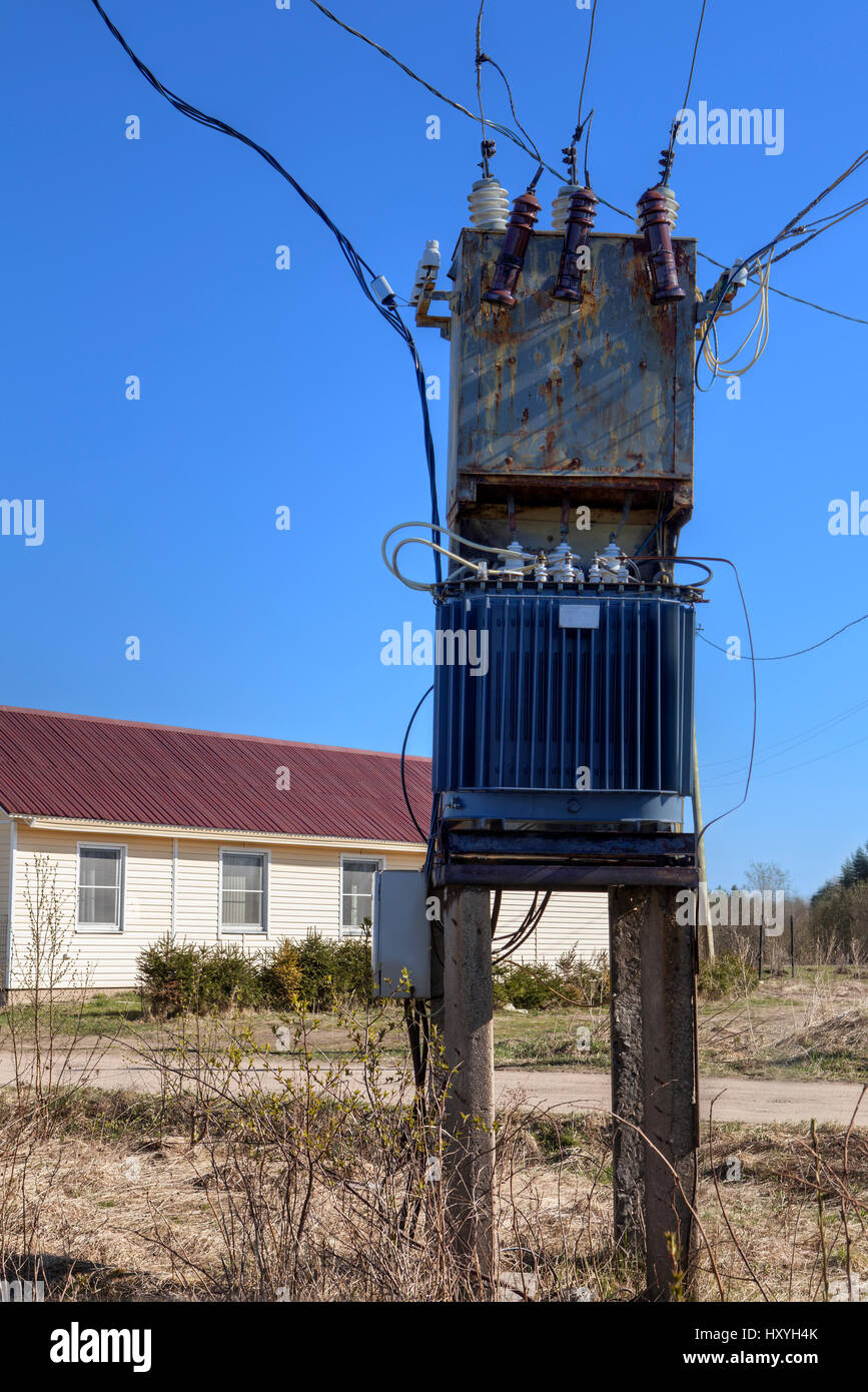 Voltage power transformer substation at village near farmhouse Stock