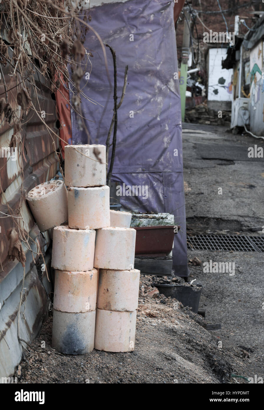 Used coal briquette on the street Stock Photo, Royalty Free Image