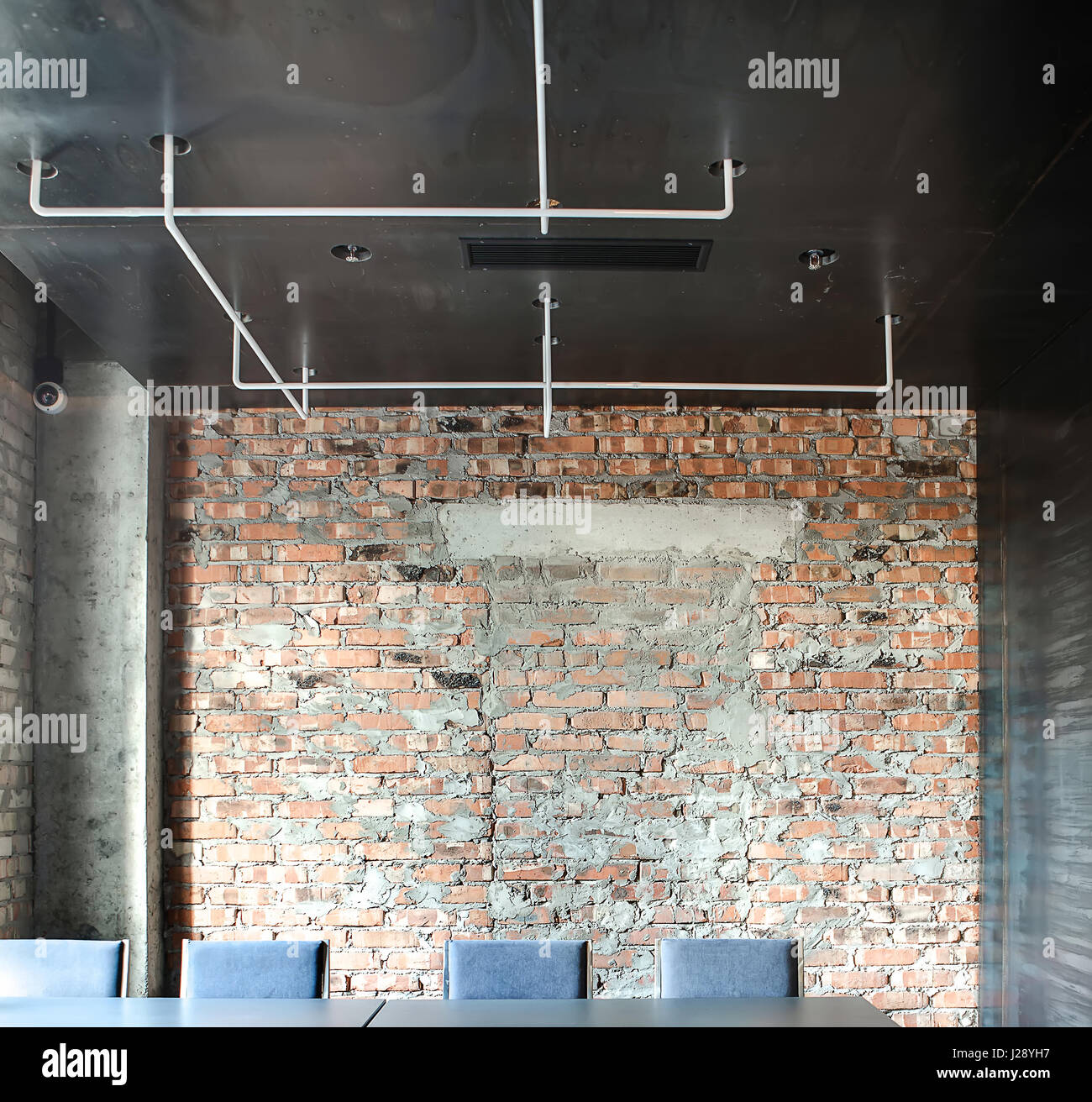 hall in a loft style in a cafe with brick walls and concrete hall in a loft style in a cafe with brick walls and concrete