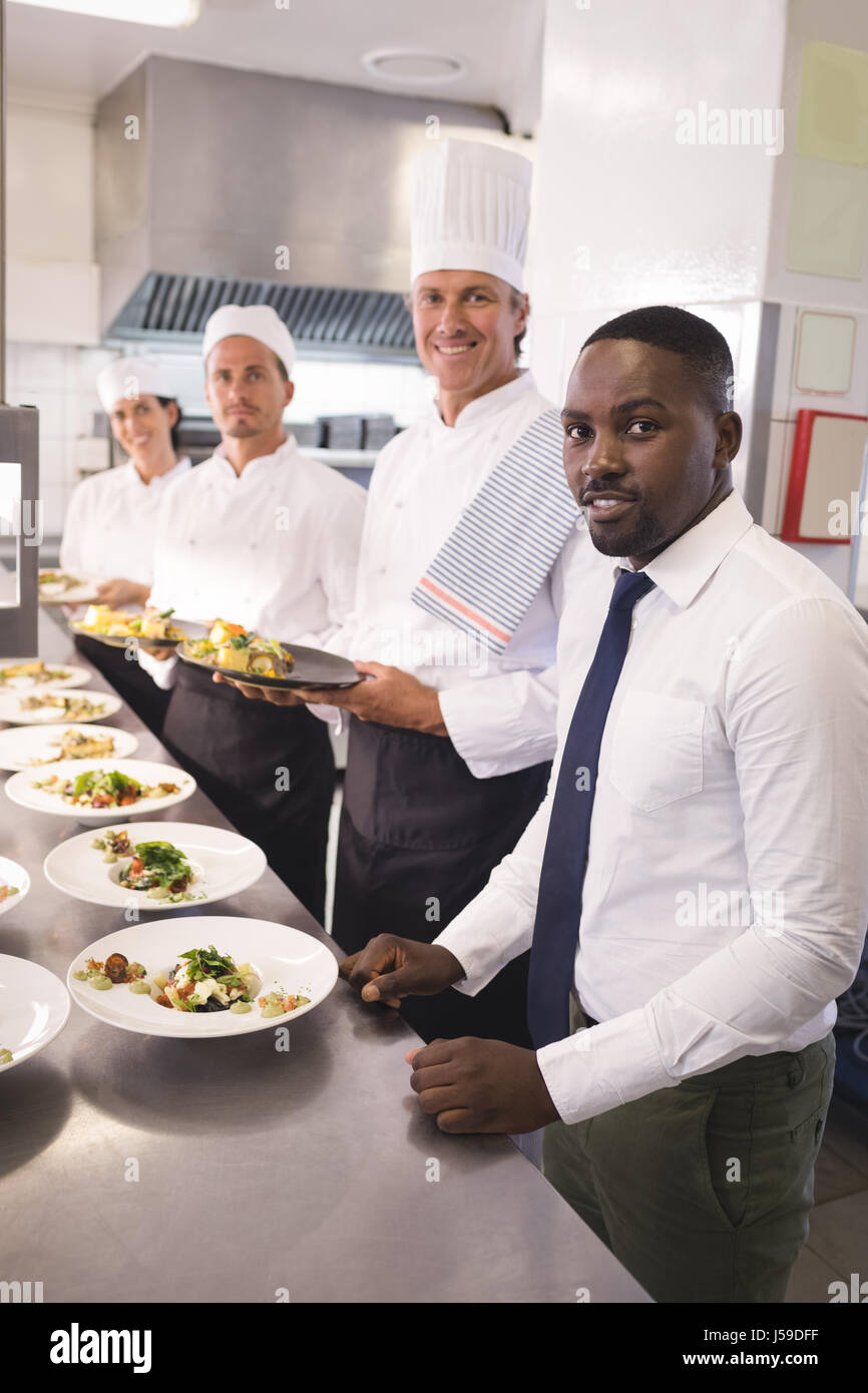 Restaurant Kitchen Staff portrait of restaurant manager with his kitchen staff in the stock Restaurant Kitchen Staff portrait of restaurant manager with his kitchen staff in the stock