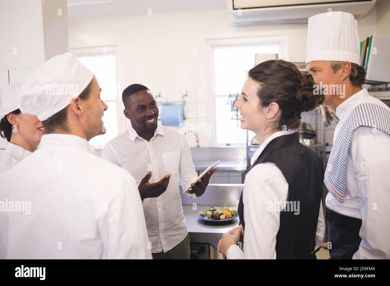 Restaurant Kitchen Staff male restaurant manager briefing to his kitchen staff in the stock Restaurant Kitchen Staff male restaurant manager briefing to his kitchen staff in the stock