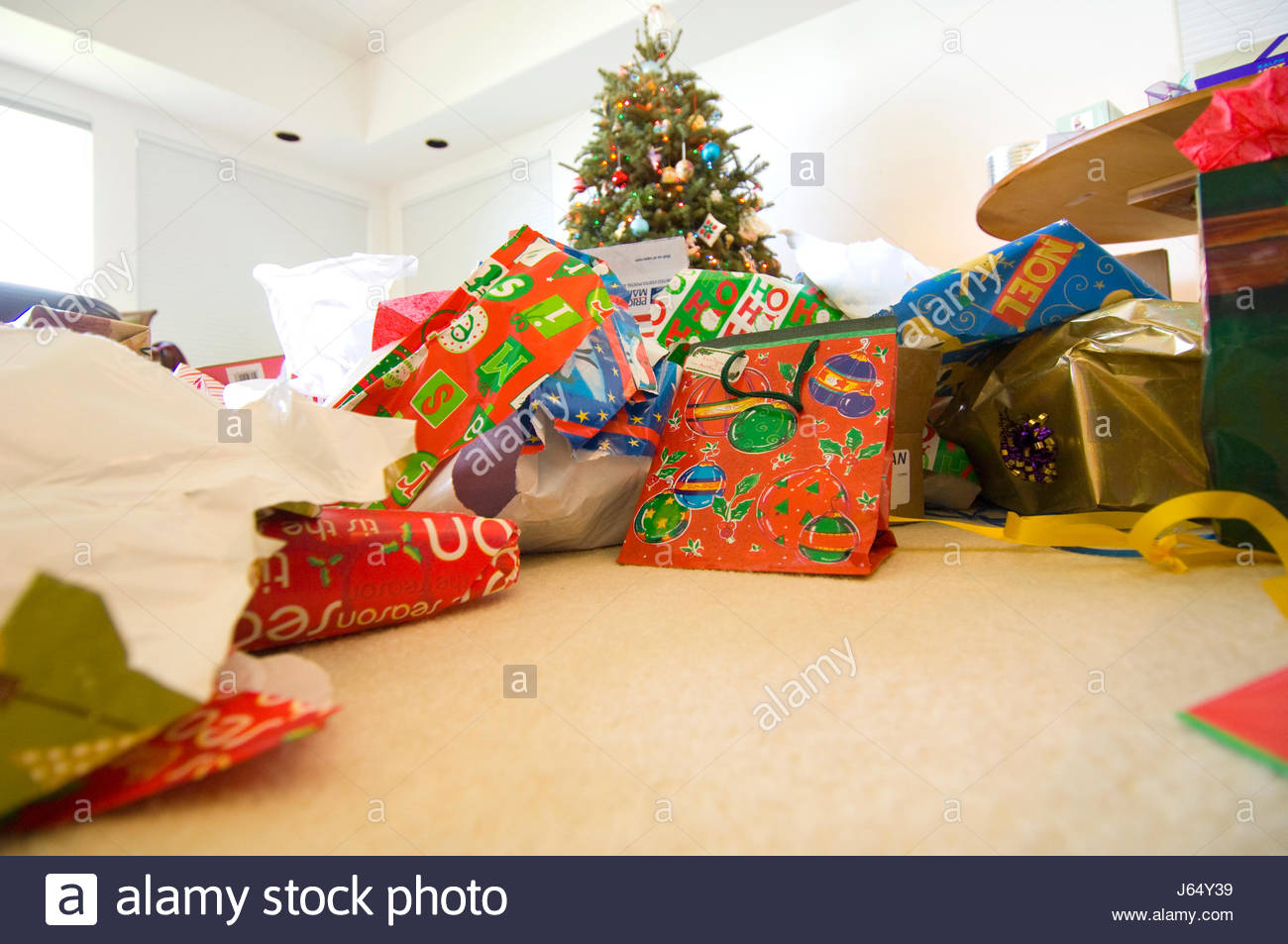 Piles of discarded wrapping paper and boxes from opened gifts Stock