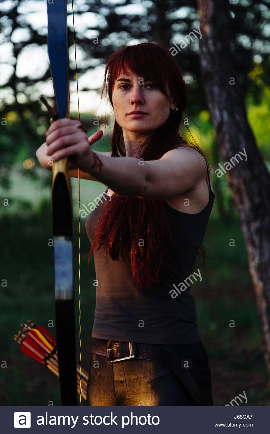 Female Archer Shooting Bow Arrow Stock Photos & Female Archer Shooting