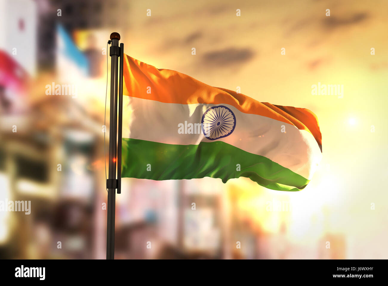 India Flag Against City Blurred Background At Sunrise Backlight