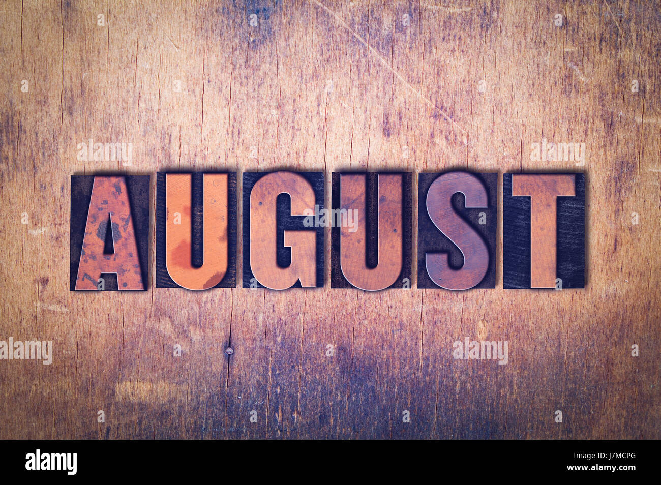 The word August concept and theme written in vintage wooden Stock Photo