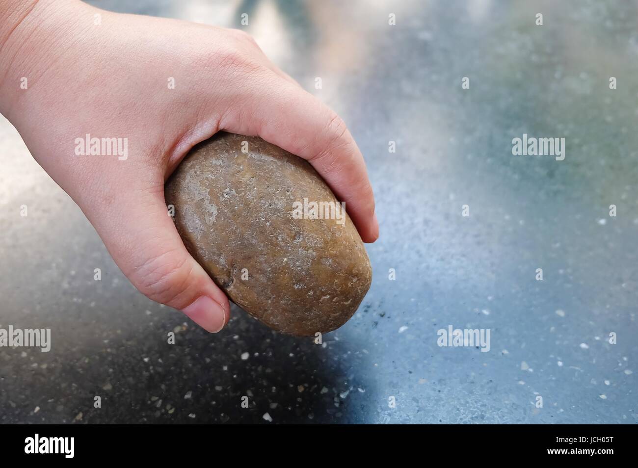 Ecology And Environment Concept Hand Holding Carefully A Brown Pebble