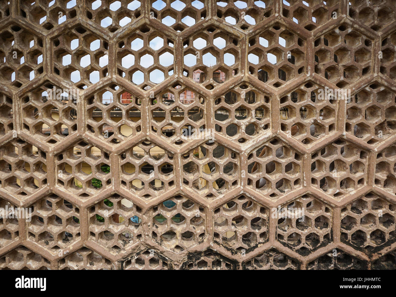stone louver with window at the ancient castle in jaipur, india stone louver with window at the ancient castle in jaipur, india