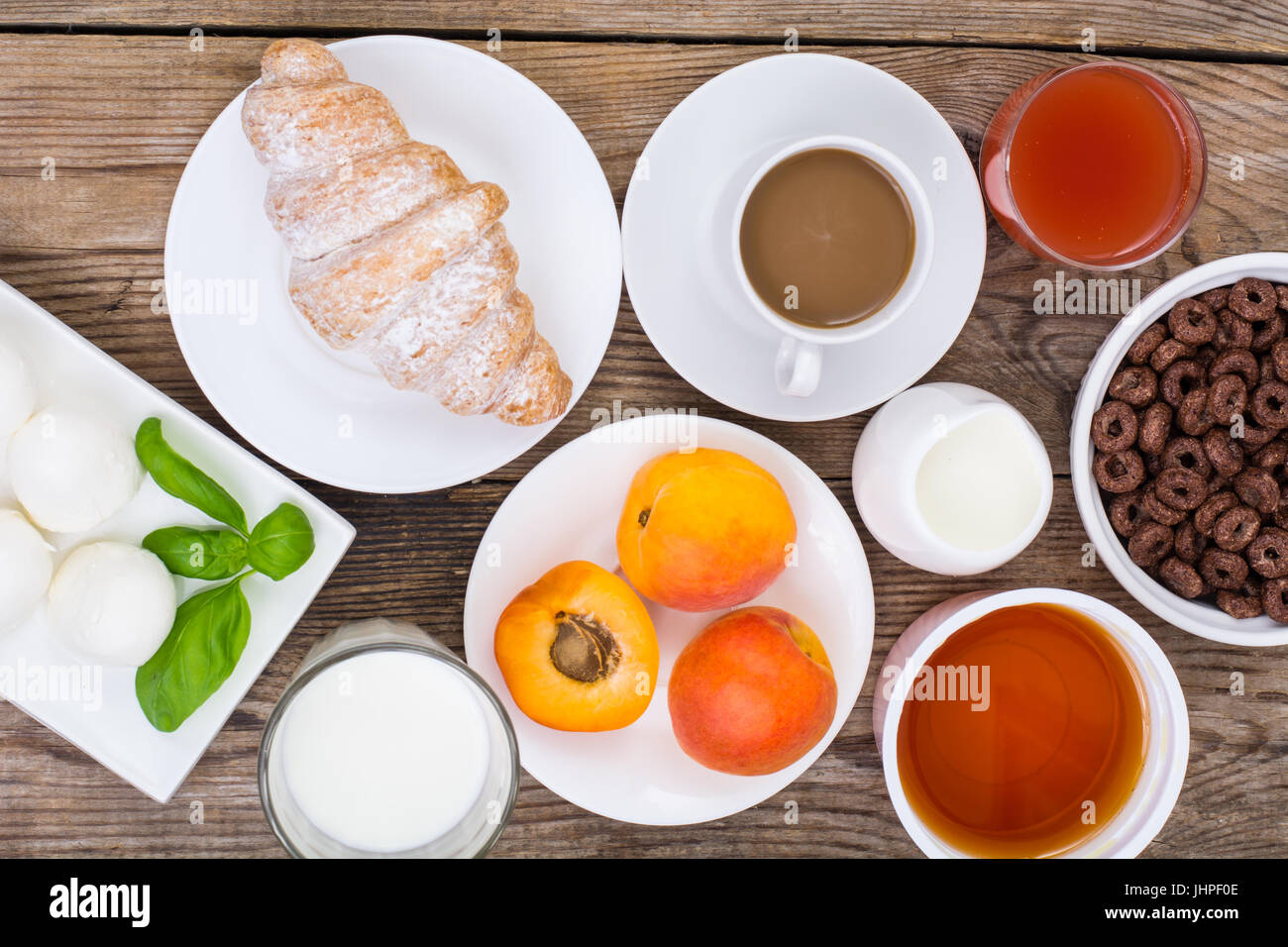 Breakfast table setting with chocolate flakes, mozzarella, juice ... Breakfast table setting with chocolate flakes, mozzarella, juice ...