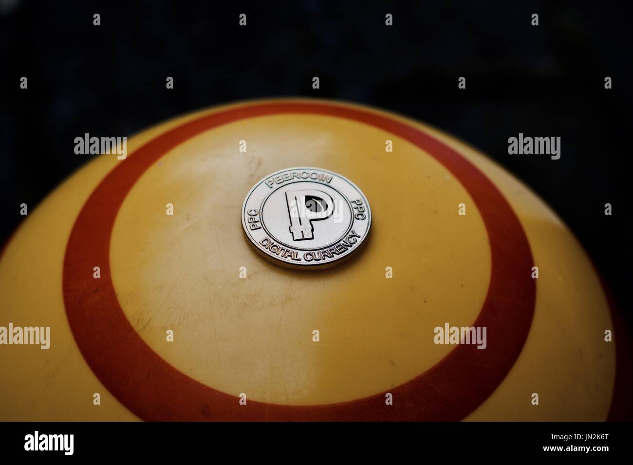 digital-currency-physical-gold-peercoin-coin-on-yellow-circle-background-JN2K6T.jpg