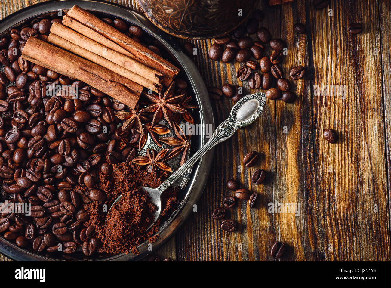 Coffee Beans With Spooonful Of Ground Coffee Cinnamon Sticks And