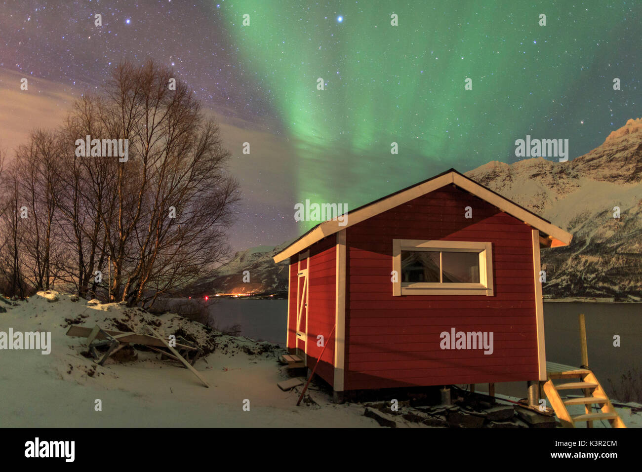 The Northern Lights Illuminates The Wooden Cabin Oteren