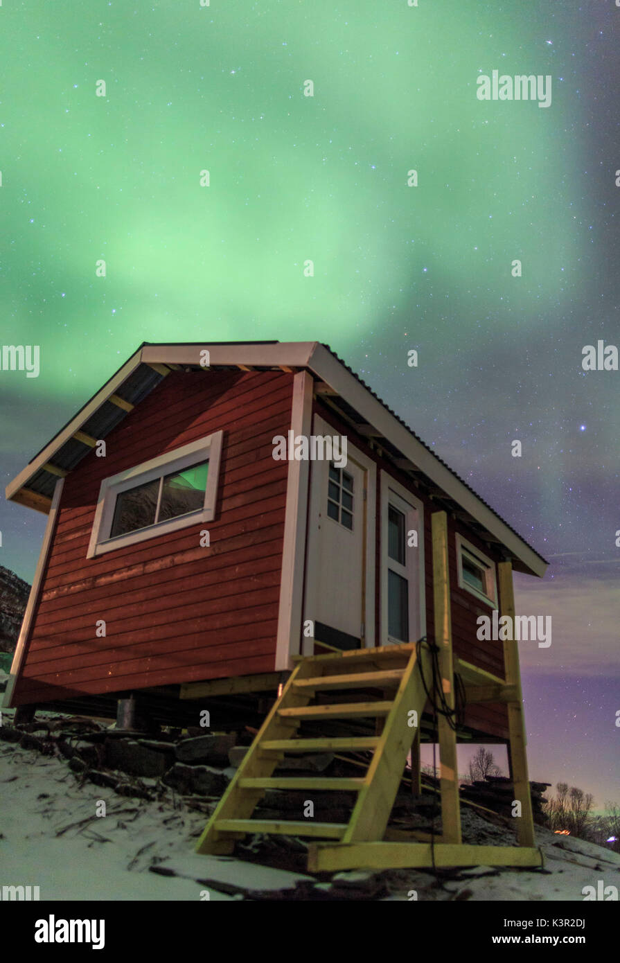 The Northern Lights Illuminates The Wooden Cabin Oteren